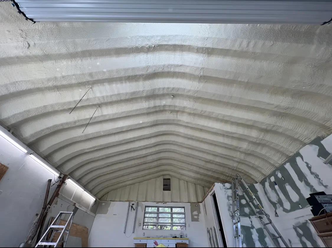 Spray polyurethane foam applied to the underside of a metal roof deck in Albion